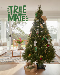 Decorated real Christmas tree standing in a Tree Mate stand in a bright living room